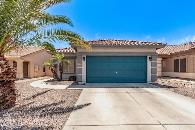 view of front of property featuring a tiled roof, an attached garage, driveway, and stucco siding