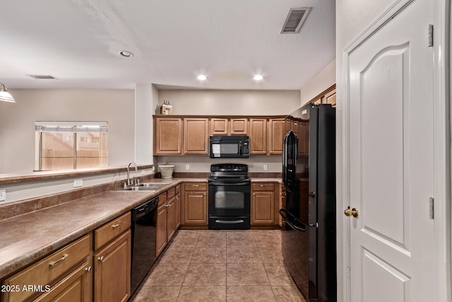 kitchen featuring a sink, black appliances, recessed lighting, and visible vents