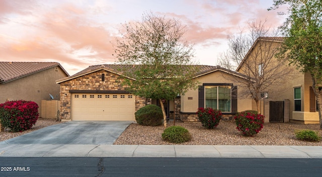 ranch-style house with driveway, stone siding, a tile roof, and a garage