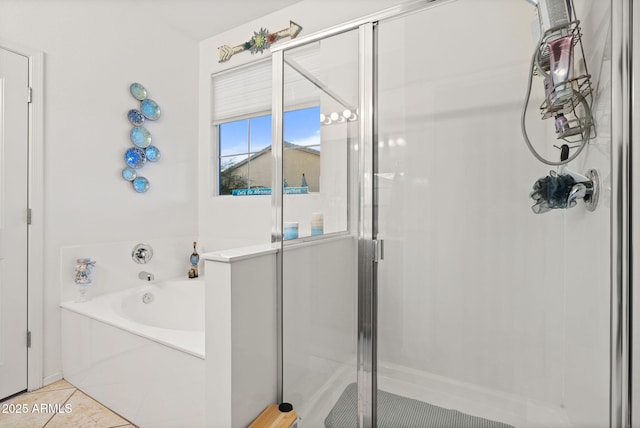 bathroom featuring a garden tub, a shower stall, and tile patterned floors