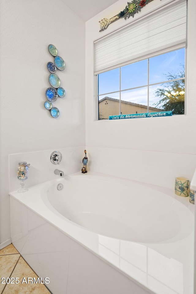 bathroom featuring a garden tub and tile patterned flooring