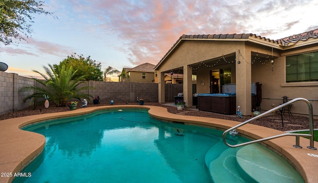 view of pool with a fenced in pool, a fenced backyard, a patio, and a hot tub