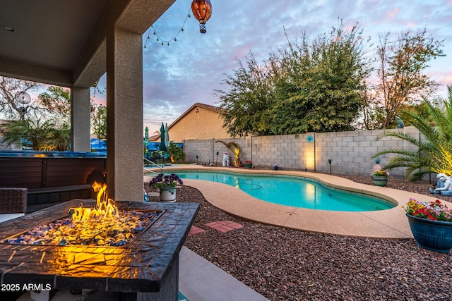 view of pool with an outdoor fire pit, a fenced backyard, a fenced in pool, and a patio