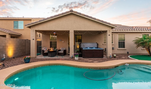 pool at dusk featuring a patio area, fence, an outdoor living space, and a fenced in pool