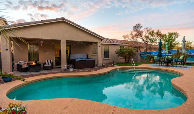 outdoor pool featuring a patio area, outdoor lounge area, and a hot tub