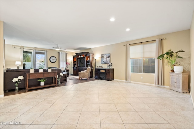 tiled living area with recessed lighting, ceiling fan, and baseboards