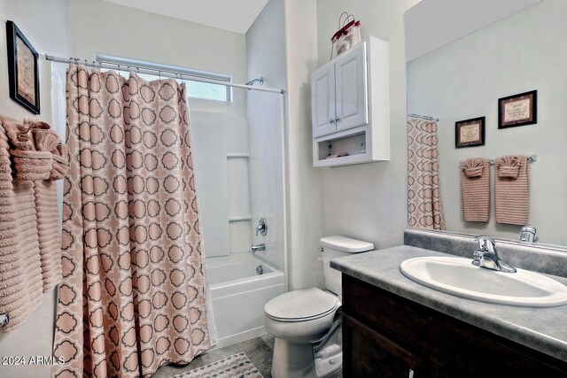 full bathroom featuring vanity, shower / bath combo, and toilet