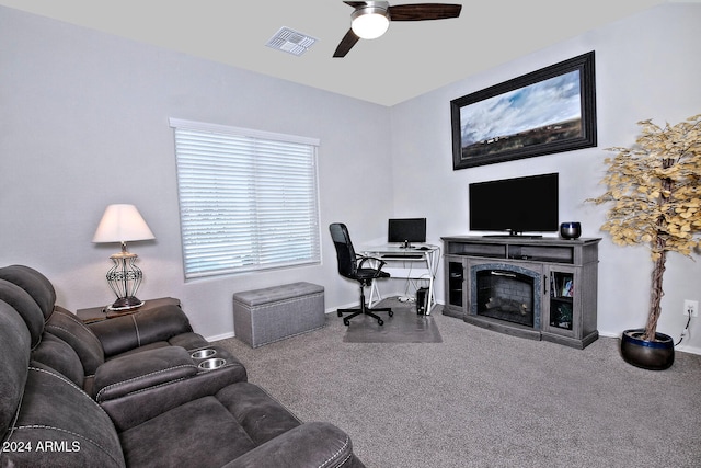 carpeted home office featuring ceiling fan