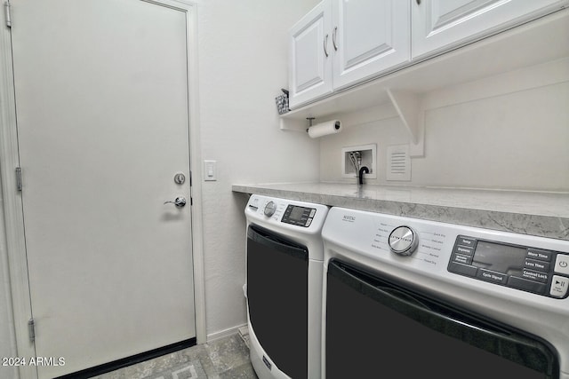 clothes washing area featuring separate washer and dryer and cabinets