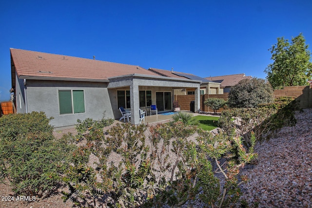 back of house with a patio