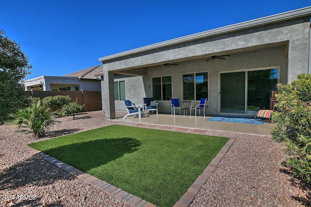 rear view of house with a yard, ceiling fan, and a patio area