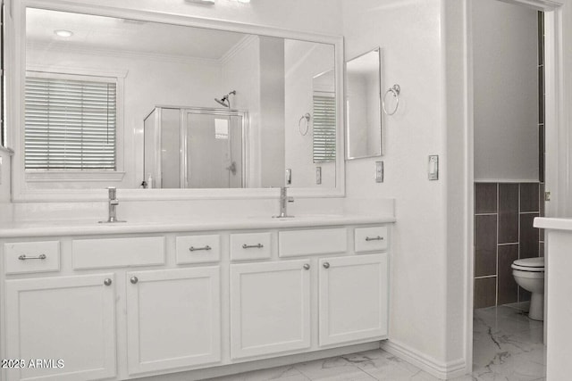 11983 W Fillmore St, Avondale, AZ 85323 - bathroom featuring a shower stall, a sink, double vanity, ornamental molding, and marble finish floor