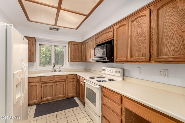 5200 S Lakeshore Dr Unit 206, Tempe, AZ 85283 - kitchen featuring white appliances, a sink, light tile patterned flooring, and brown cabinets