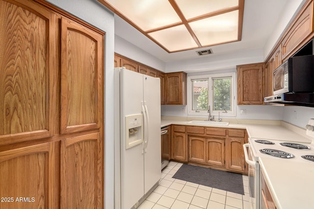 5200 S Lakeshore Dr Unit 206, Tempe, AZ 85283 - kitchen featuring white appliances, a sink, brown cabinetry, and light tile patterned floors