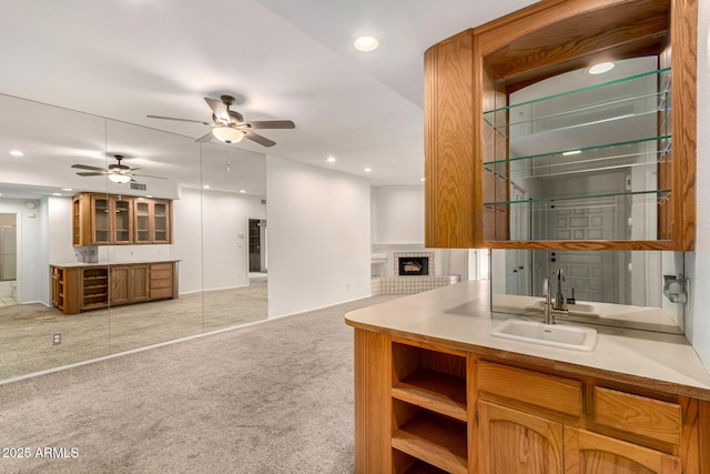 5200 S Lakeshore Dr Unit 206, Tempe, AZ 85283 - kitchen with a sink, light colored carpet, a brick fireplace, a ceiling fan, and recessed lighting