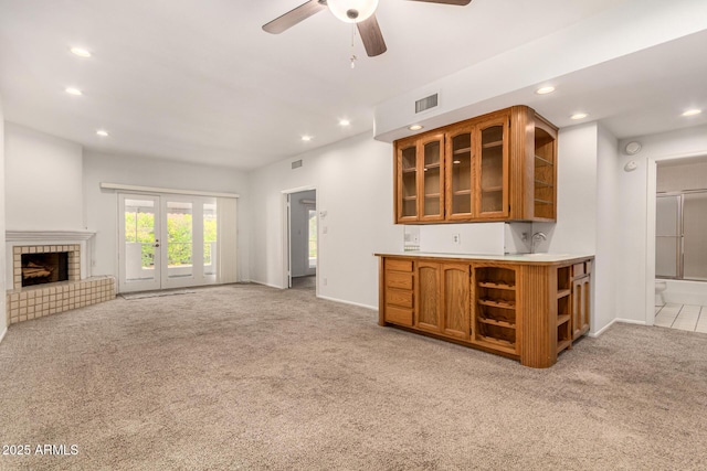 5200 S Lakeshore Dr Unit 206, Tempe, AZ 85283 - kitchen featuring open shelves, light carpet, brown cabinetry, recessed lighting, and glass insert cabinets