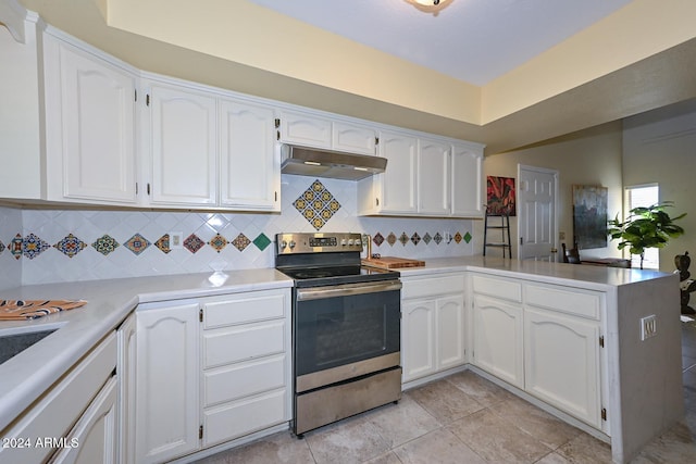 kitchen with white cabinets, kitchen peninsula, and electric stove