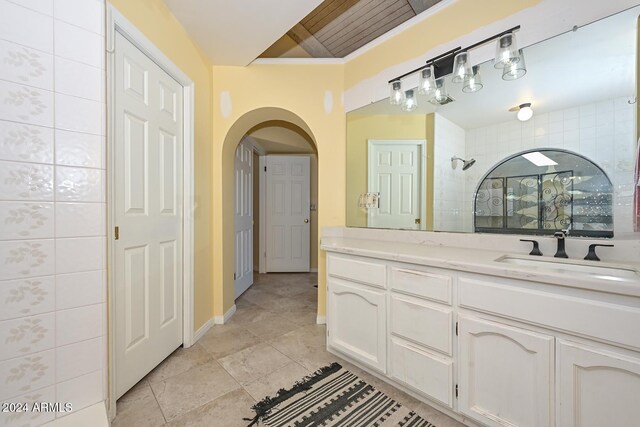 bathroom with vanity and a shower