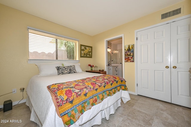 bedroom featuring a closet and ensuite bath