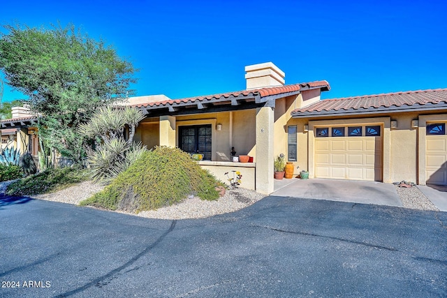 mediterranean / spanish-style house with a garage