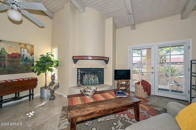 living room with ceiling fan, wooden ceiling, and vaulted ceiling with beams