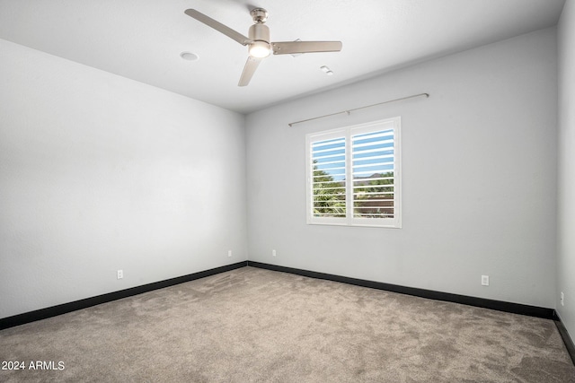 spare room featuring ceiling fan and carpet flooring