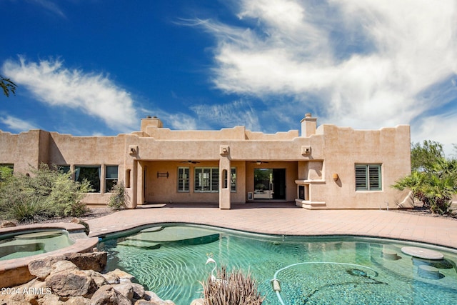 view of swimming pool with an in ground hot tub and a patio area