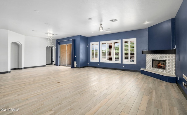 unfurnished living room with light wood-type flooring and a fireplace