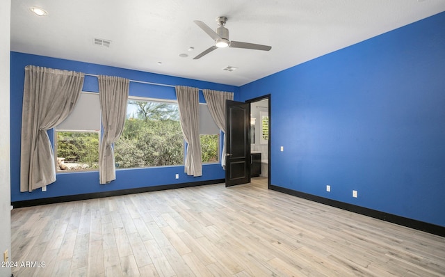 empty room with light wood-type flooring and ceiling fan