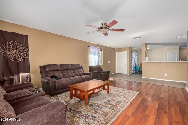 living room featuring light tile flooring and ceiling fan