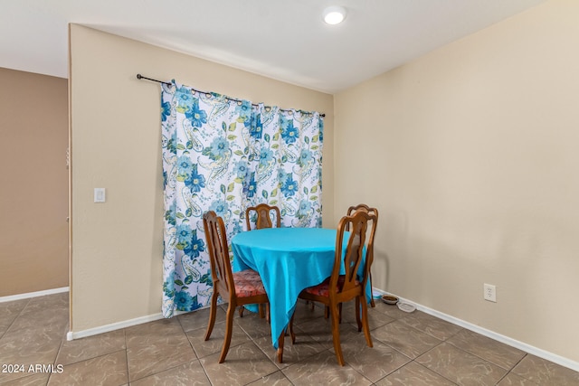 dining area with dark tile flooring