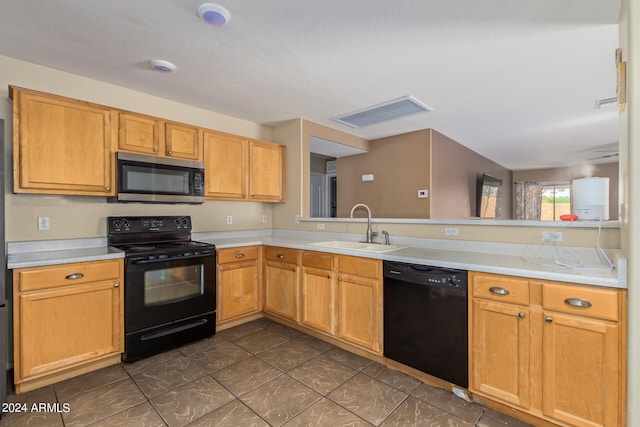 kitchen with kitchen peninsula, dark tile floors, black appliances, and sink