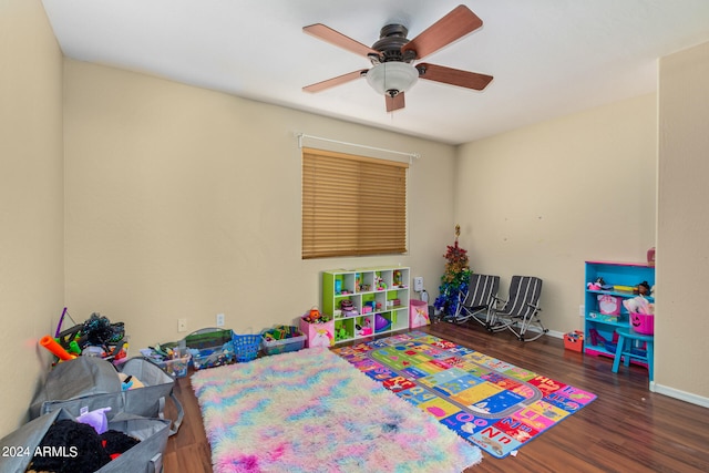 playroom featuring ceiling fan and dark wood-type flooring