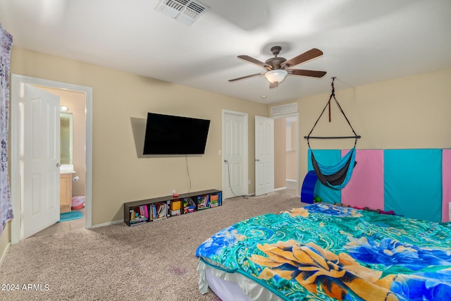 bedroom featuring light colored carpet, connected bathroom, and ceiling fan