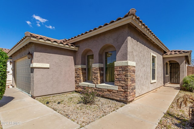 mediterranean / spanish-style home featuring a garage