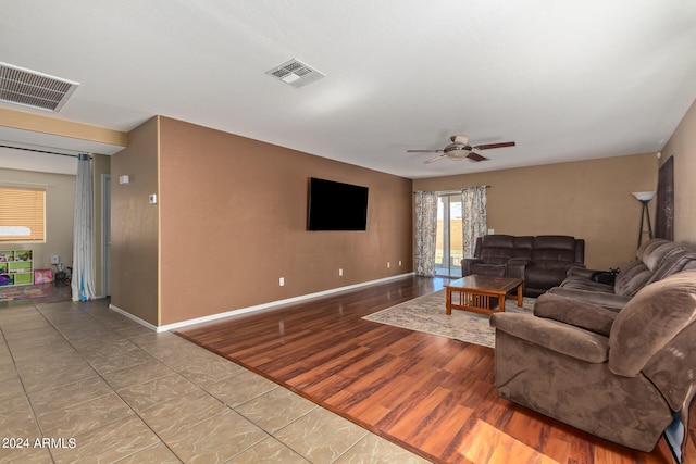 tiled living room featuring ceiling fan