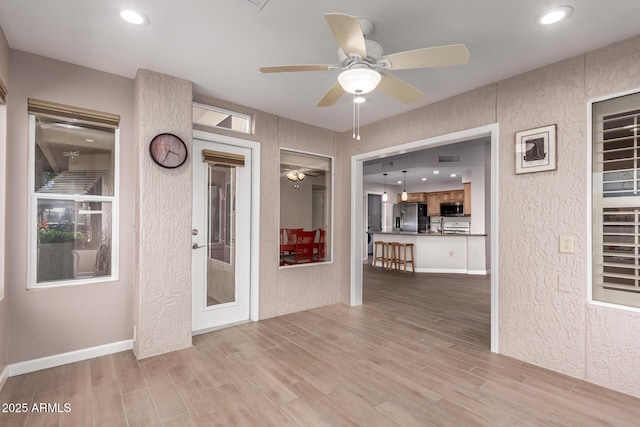 interior space featuring ceiling fan and light hardwood / wood-style floors