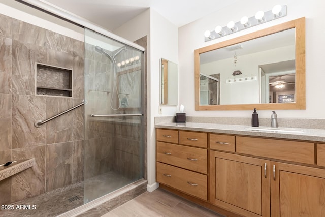 bathroom featuring vanity, hardwood / wood-style floors, and a shower with shower door