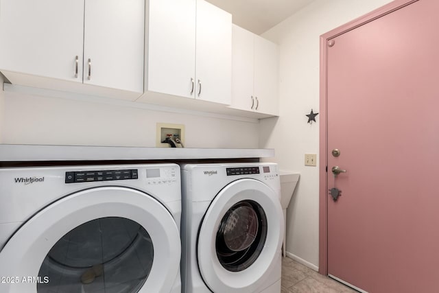 washroom with cabinets and washing machine and dryer