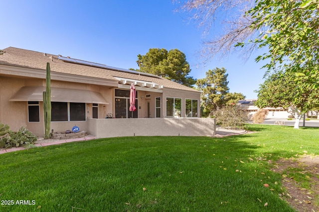 rear view of property with a yard