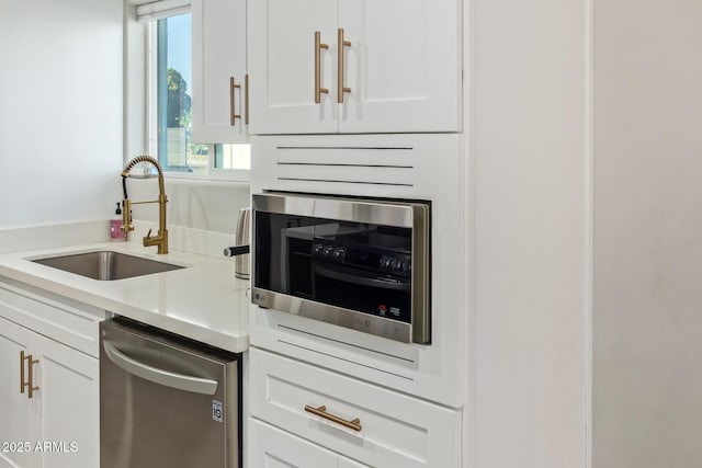 1702 W Glenrosa Ave, Phoenix, AZ 85015 - kitchen featuring a sink, stainless steel appliances, healthy amount of natural light, and white cabinets