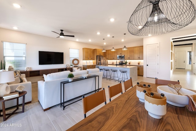 living room with light tile patterned floors and ceiling fan