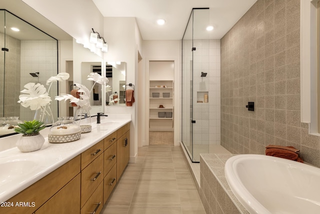 bathroom with vanity, tile patterned flooring, plus walk in shower, and tile walls