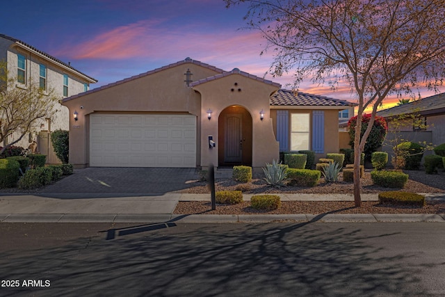 mediterranean / spanish-style home with a garage