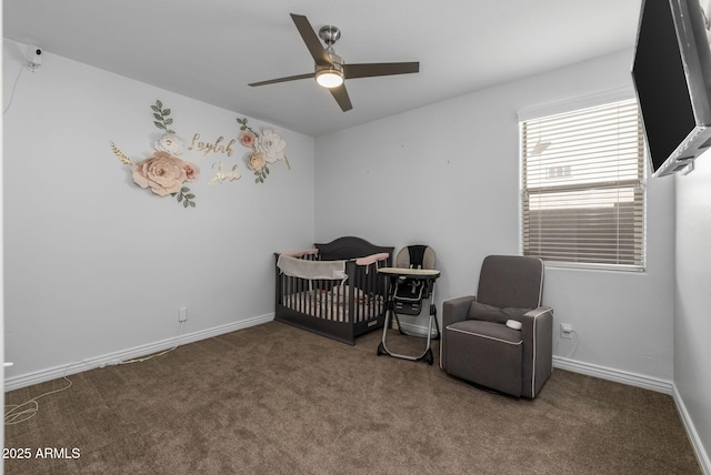 carpeted bedroom featuring ceiling fan and a crib