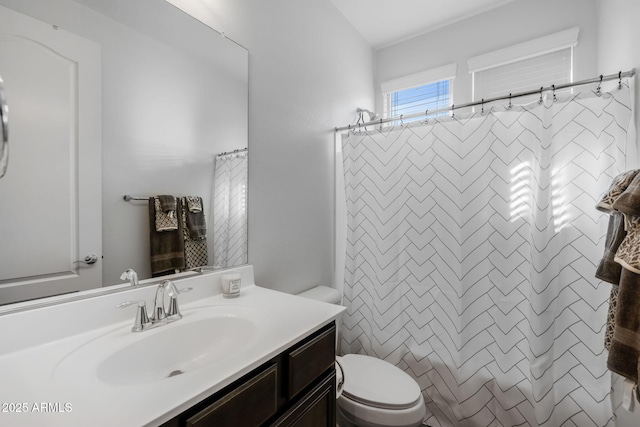 bathroom with a shower with shower curtain, vanity, and toilet