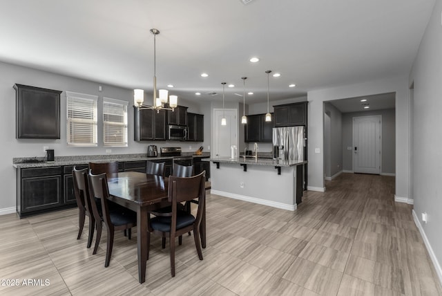 dining room featuring sink and a notable chandelier