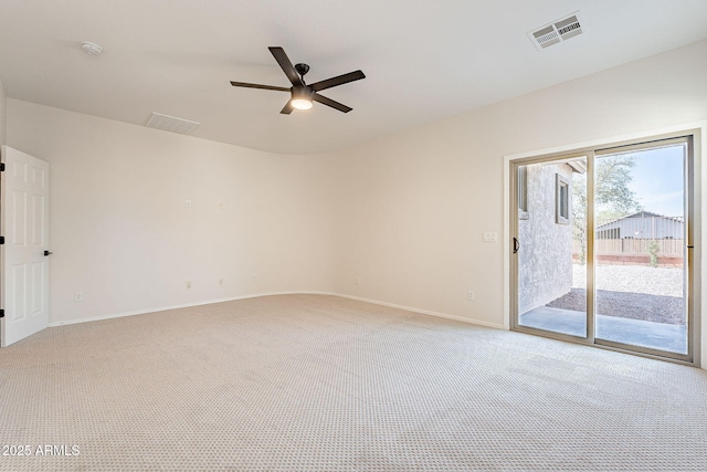 spare room featuring visible vents, ceiling fan, light carpet, and baseboards