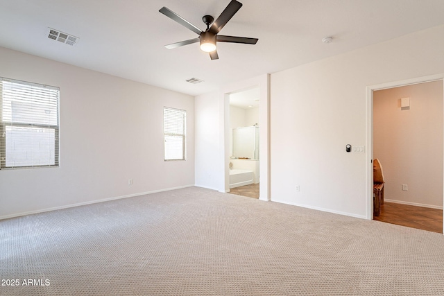 unfurnished bedroom with baseboards, visible vents, and light colored carpet