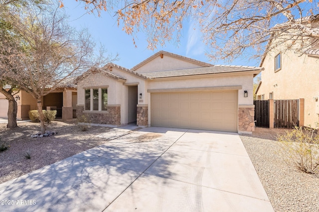 view of front facade featuring a garage, fence, stone siding, driveway, and stucco siding